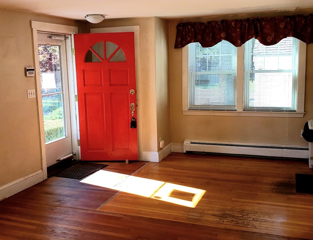 792 Ash Street Brockton, MA 02301 - Photo 37 of 42 a view of an empty room with wooden floor and a window