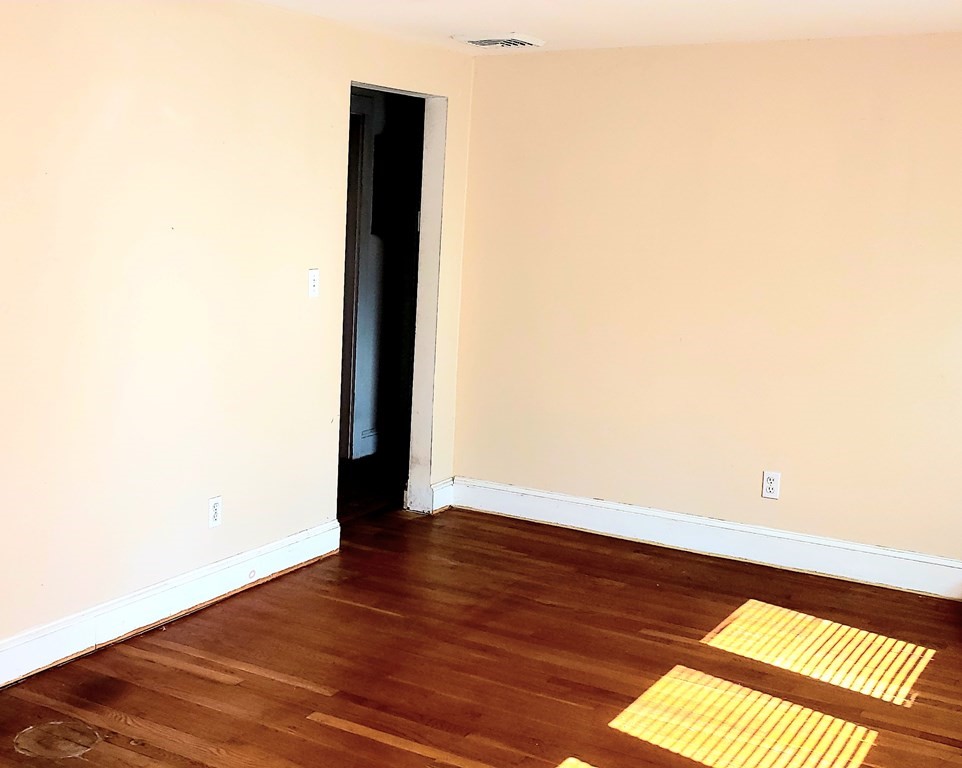 792 Ash Street Brockton, MA 02301 - Photo 40 of 42 a view of an empty room with wooden floor