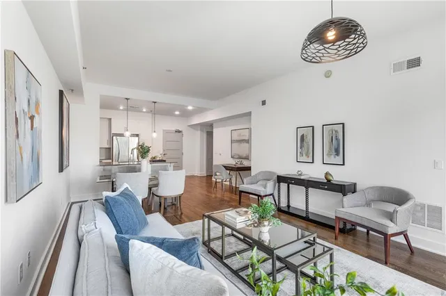 a view of a dining room with furniture and chandelier