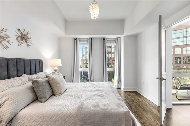 a bedroom with a large bed and a chandelier