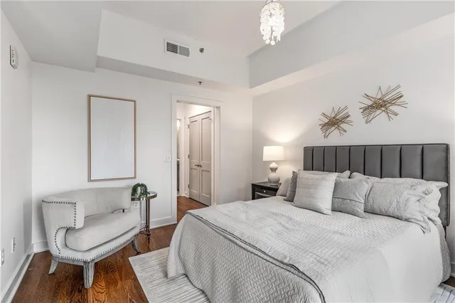 a bedroom with bed and chair