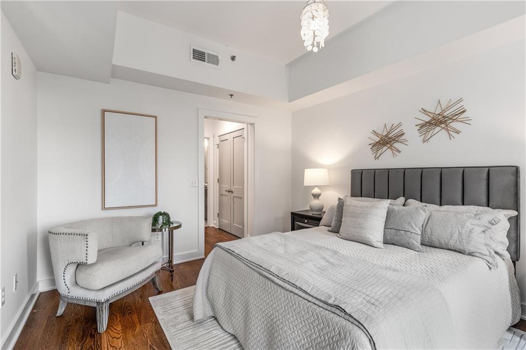 1100 Howell Mill Road Northwest, Unit 404 Atlanta, GA 30318 - Photo 17 of 45 a bedroom with bed and chair