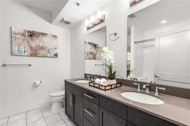 a bathroom with a toilet a sink and mirror