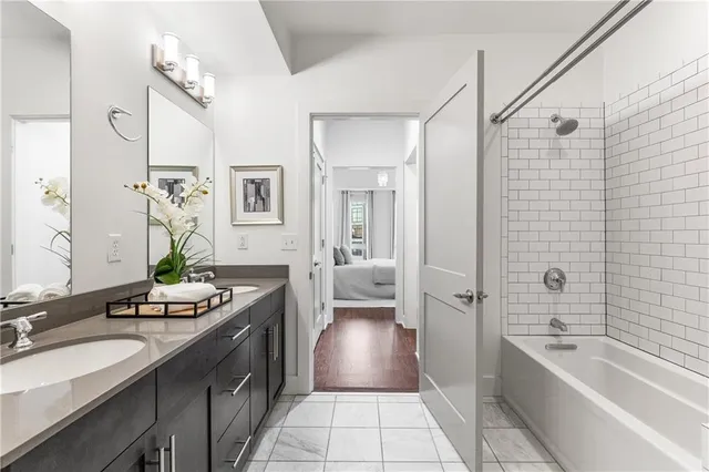 a spacious bathroom with a tub sink and mirror