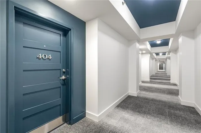 a view of a hallway with wooden cabinets