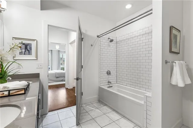 a spacious bathroom with a sink a mirror and a bathtub