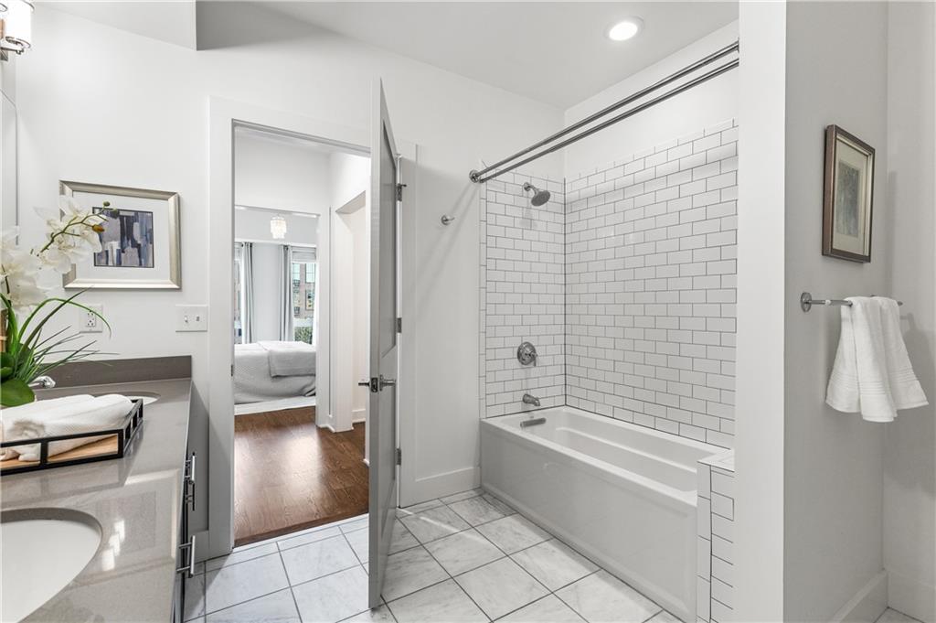 1100 Howell Mill Road Northwest, Unit 404 Atlanta, GA 30318 - Photo 21 of 45 a spacious bathroom with a sink a mirror and a bathtub