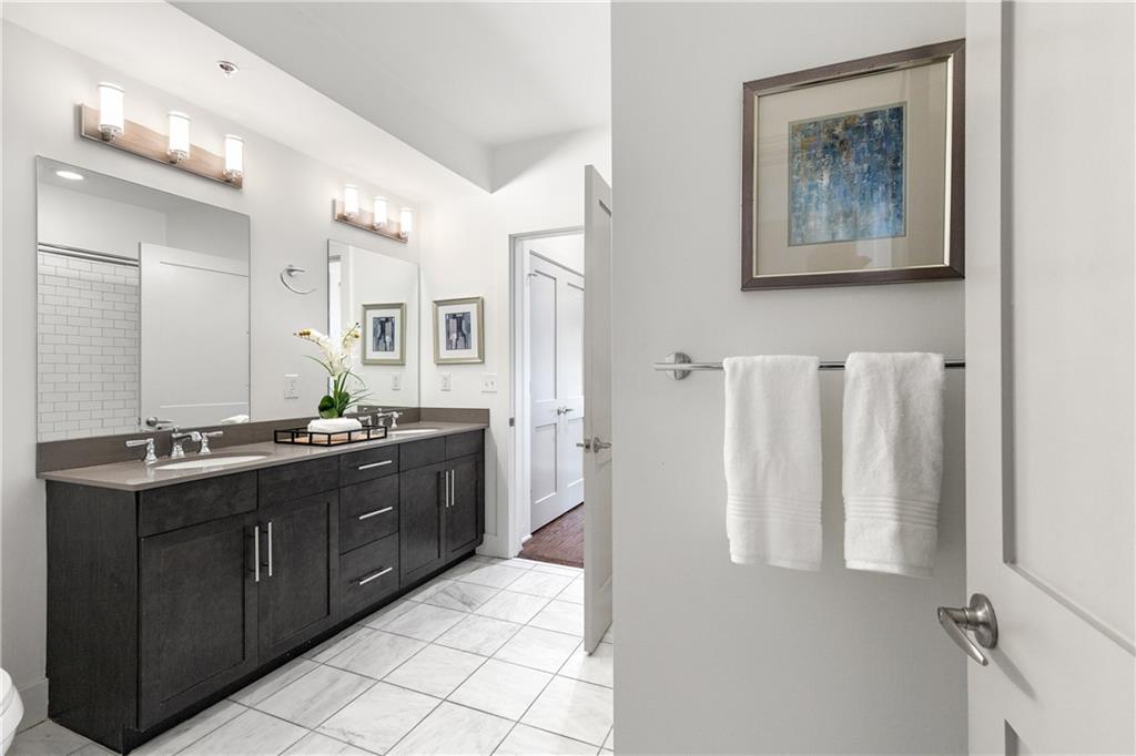 1100 Howell Mill Road Northwest, Unit 404 Atlanta, GA 30318 - Photo 22 of 45 a spacious bathroom with a double vanity sink a mirror and a shower