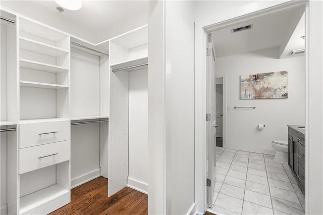 a view of walk in closet with empty racks