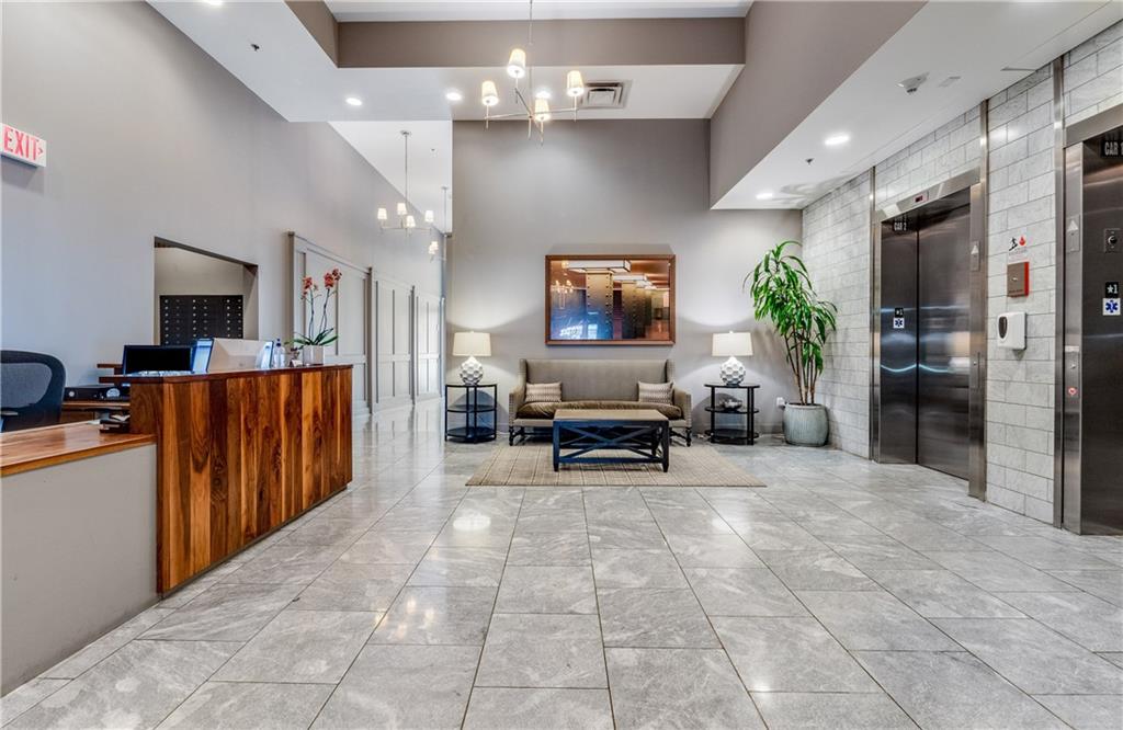 1100 Howell Mill Road Northwest, Unit 404 Atlanta, GA 30318 - Photo 33 of 45 a view of a livingroom with furniture and a flat screen tv