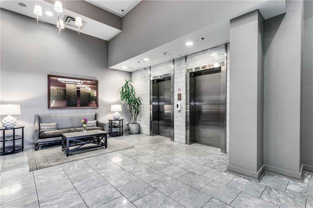 1100 Howell Mill Road Northwest, Unit 404 Atlanta, GA 30318 - Photo 34 of 45 a living room with furniture and a flat screen tv