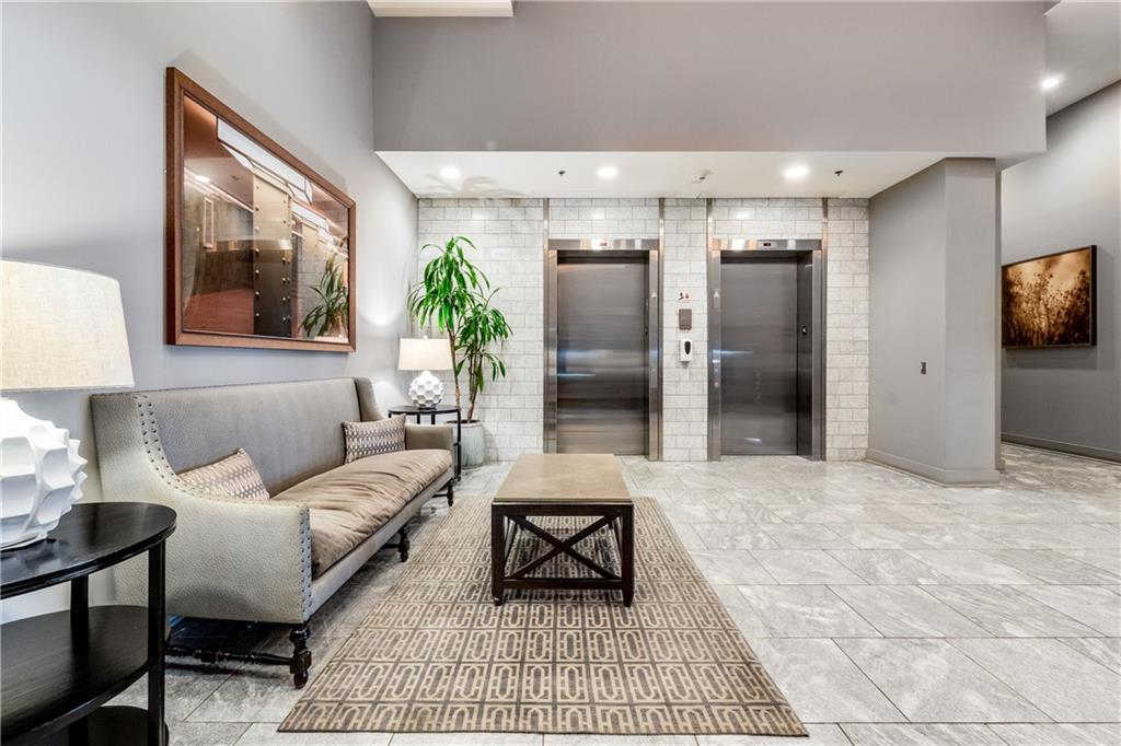 1100 Howell Mill Road Northwest, Unit 404 Atlanta, GA 30318 - Photo 35 of 45 a living room with furniture a large window and a potted plant