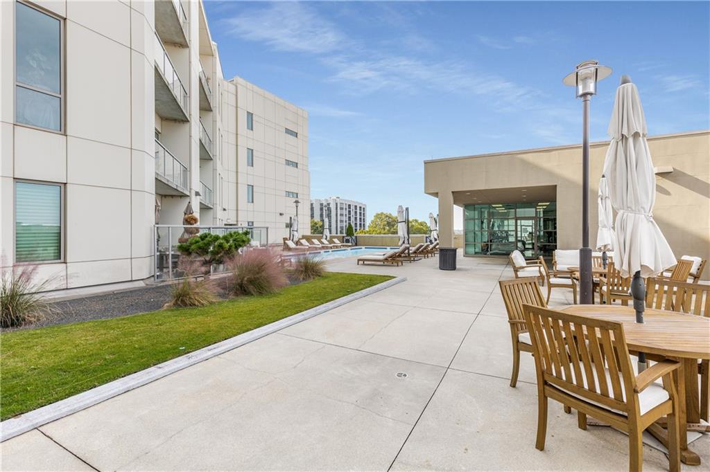 1100 Howell Mill Road Northwest, Unit 404 Atlanta, GA 30318 - Photo 38 of 45 a view of a patio with a table and chairs