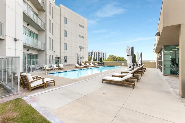 a view of swimming pool with outdoor seating and a couch