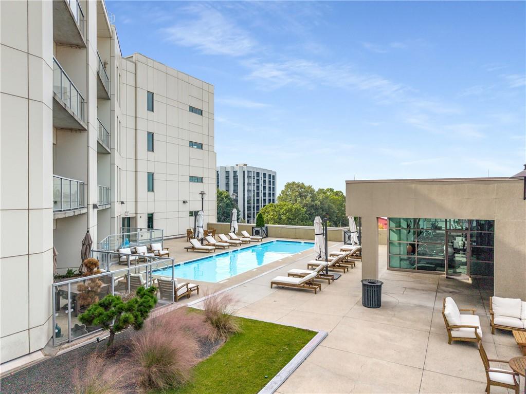 1100 Howell Mill Road Northwest, Unit 404 Atlanta, GA 30318 - Photo 42 of 45 a view of a swimming pool with chairs in front of building