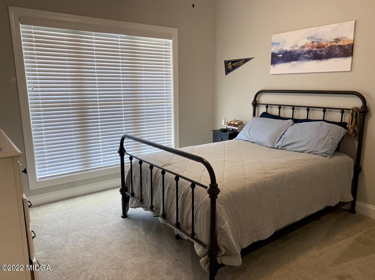 101 Carters Way Forsyth, GA 31029 - Photo 15 of 28 a bedroom with a bed and a window