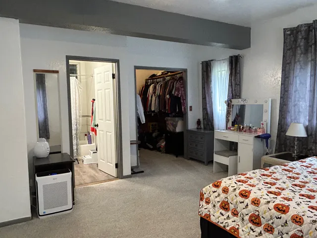 a bedroom with a bed and a mirror