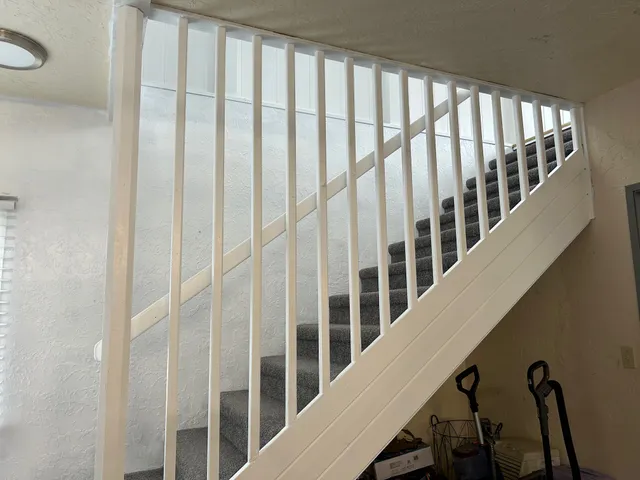a view of staircase with lots of white walls and a window