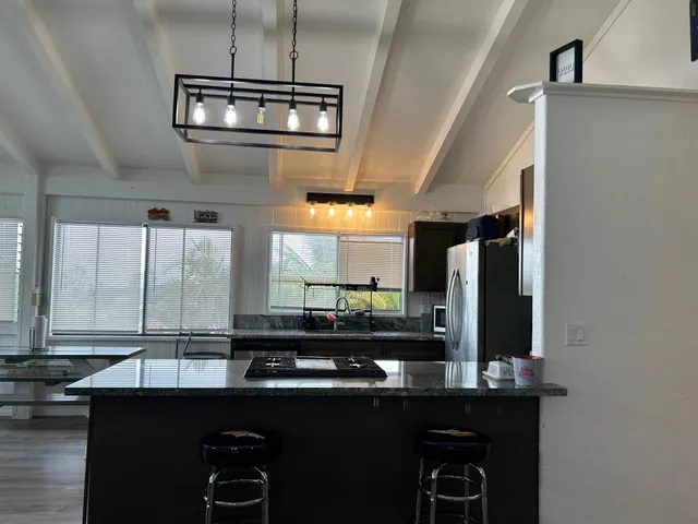 a kitchen with a sink and a refrigerator