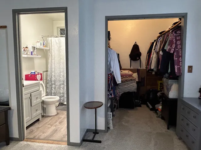 a bathroom with a toilet a sink and a mirror