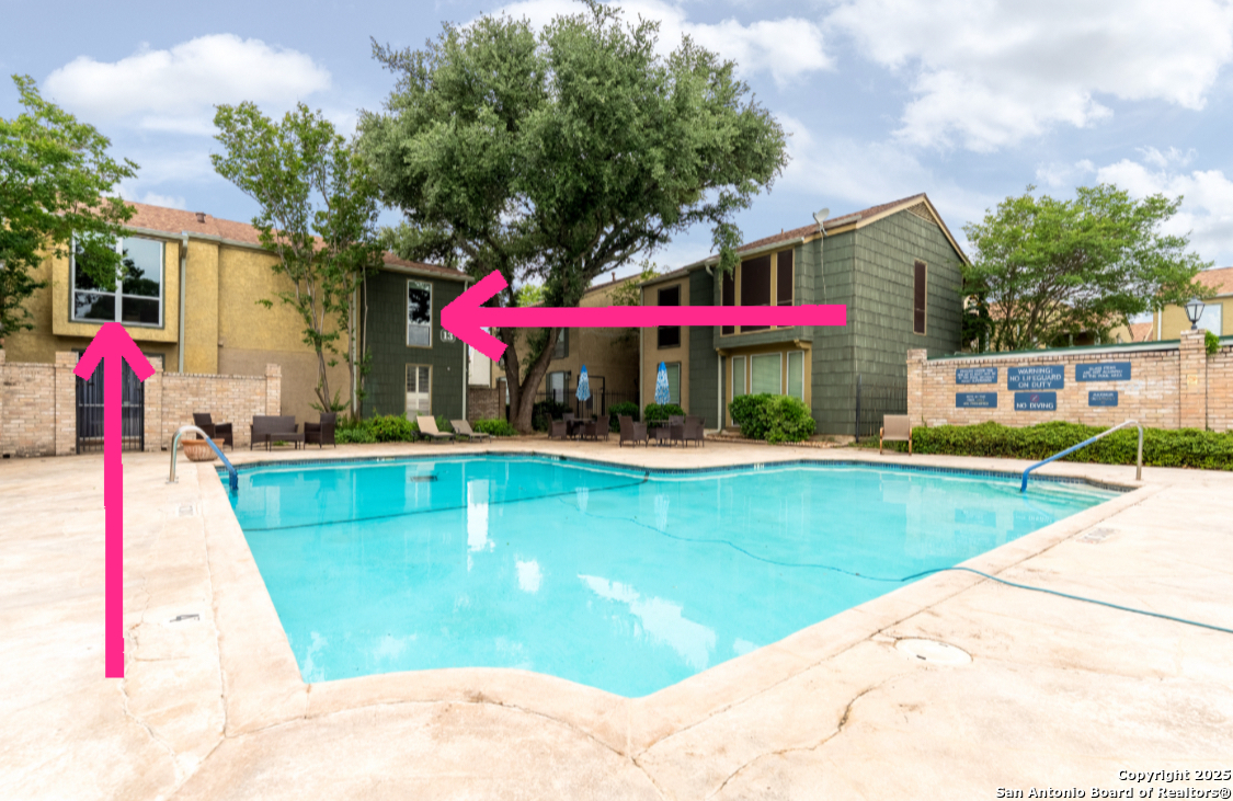 3678 Hidden Drive, Unit 1301 San Antonio, TX 78217 - Photo 26 of 47 a view of swimming pool with a lawn chairs under an umbrella