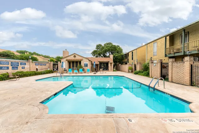a view of house with swimming pool