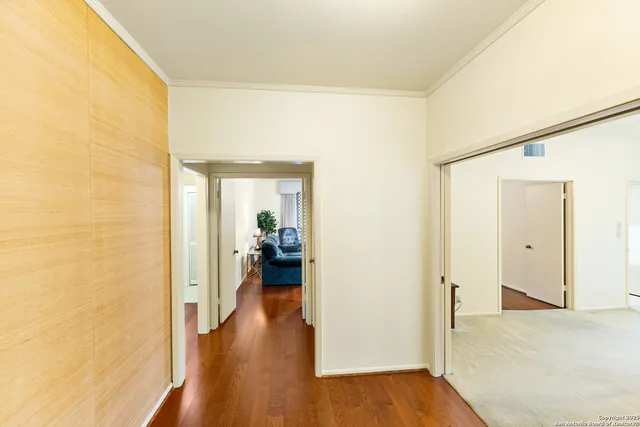 a view of a hallway with a wooden floor