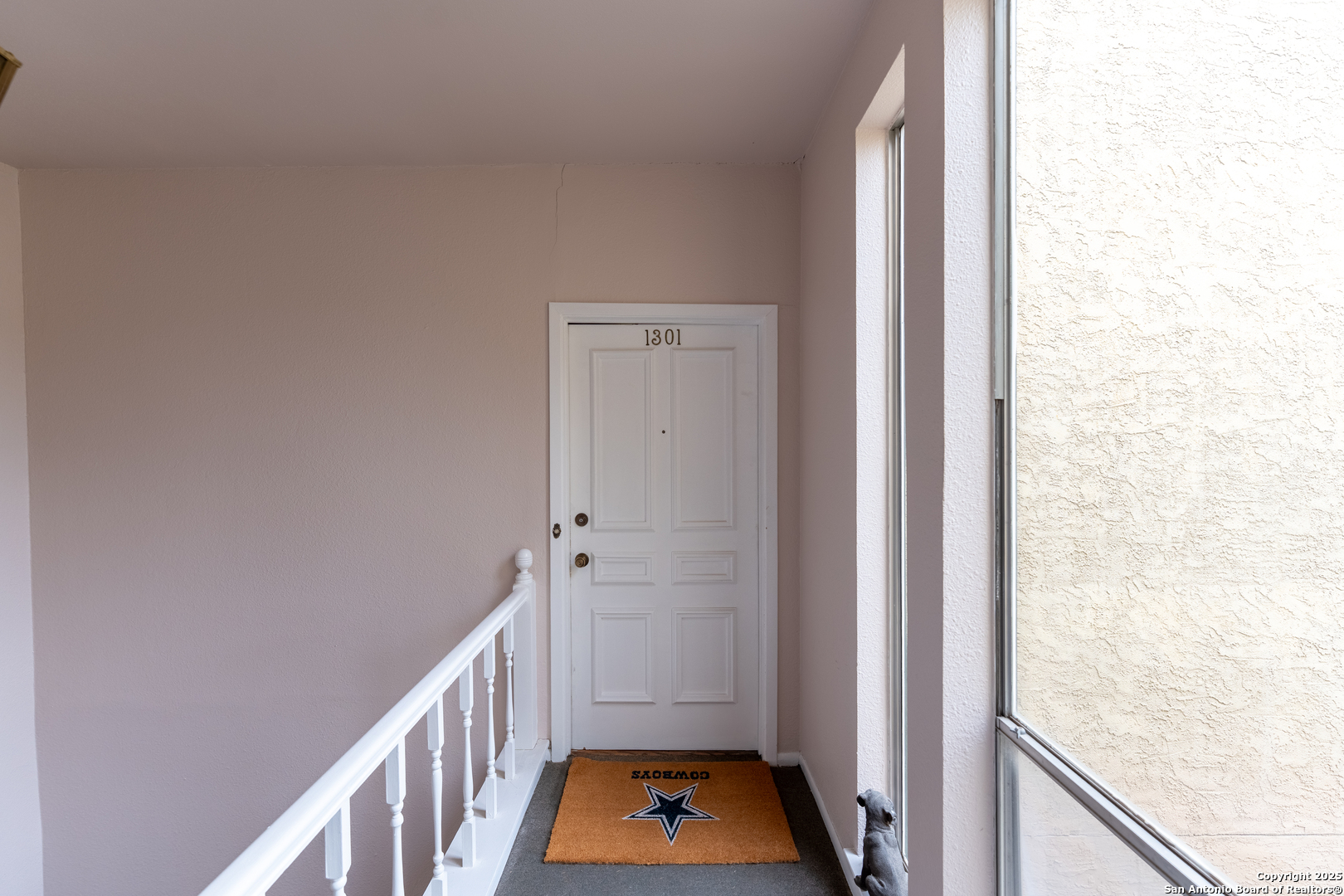 3678 Hidden Drive, Unit 1301 San Antonio, TX 78217 - Photo 33 of 47 a view of a hallway with white walls and wooden floor