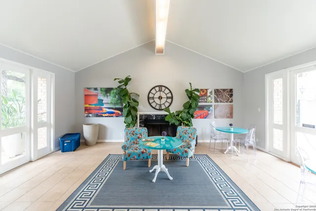 a living room with furniture a rug a clock and a window