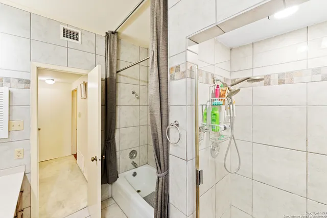 a bathroom with a shower and a sink