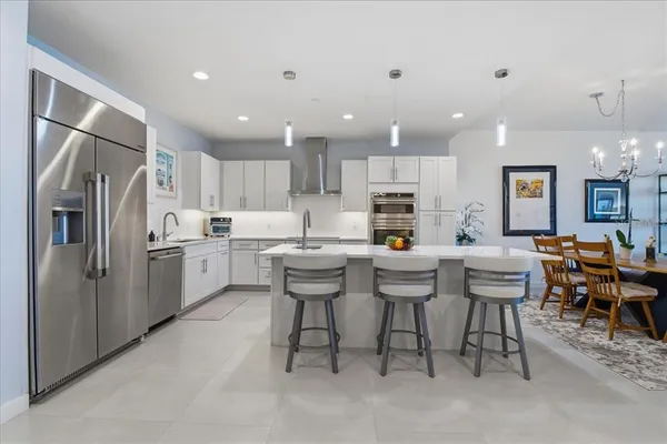 a kitchen that has a table and chairs in it