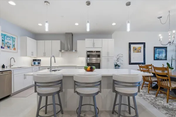 a kitchen with stainless steel appliances cabinets and a window