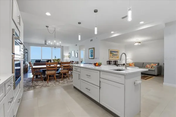 a large kitchen with stainless steel appliances lots of counter space sink refrigerator and cabinets