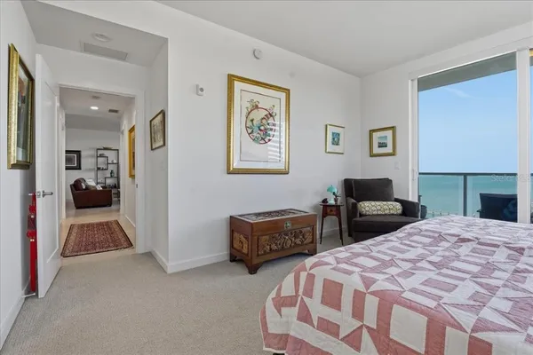 a bedroom with a bed couch and cabinet