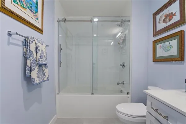 a bathroom with a shower sink and mirror