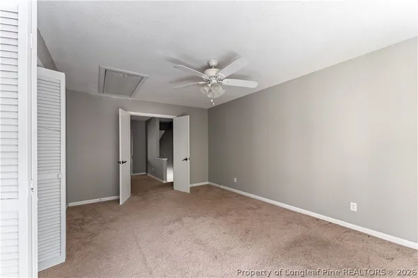 a view of an empty room with a ceiling fan