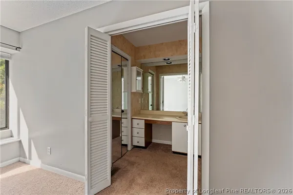 a view of bathroom with a sink and mirror