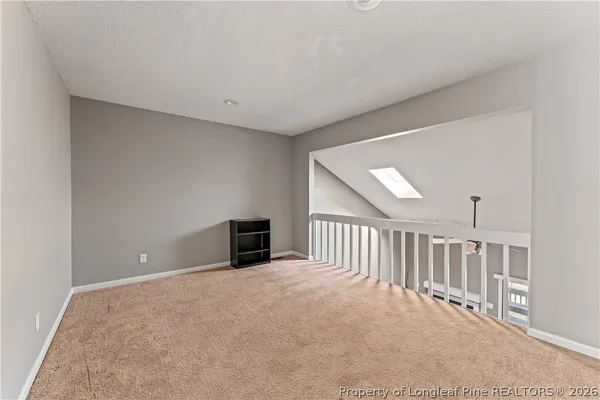 a view of an empty room with a fireplace