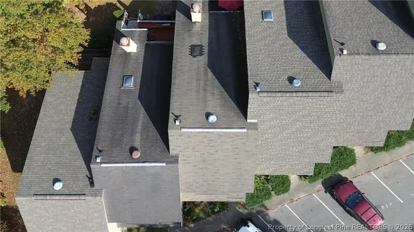 an aerial view of a house with a yard