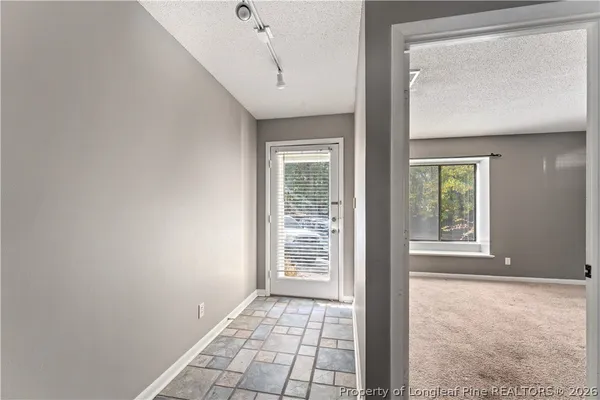 a view of an empty room with windows