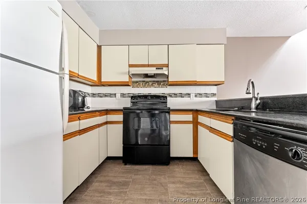 a kitchen with stainless steel appliances granite countertop a stove and a sink