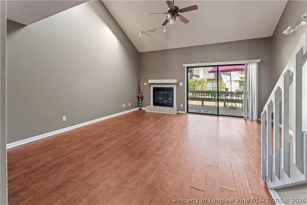 wooden floor in an empty room with a fireplace