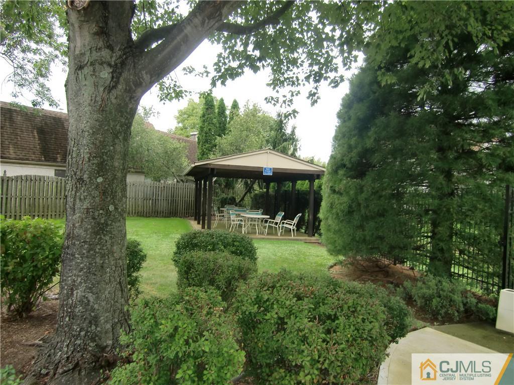 2 Park Gate Drive Edison, NJ 08820 - Photo 12 of 13 a view of backyard with a table and chairs under an umbrella
