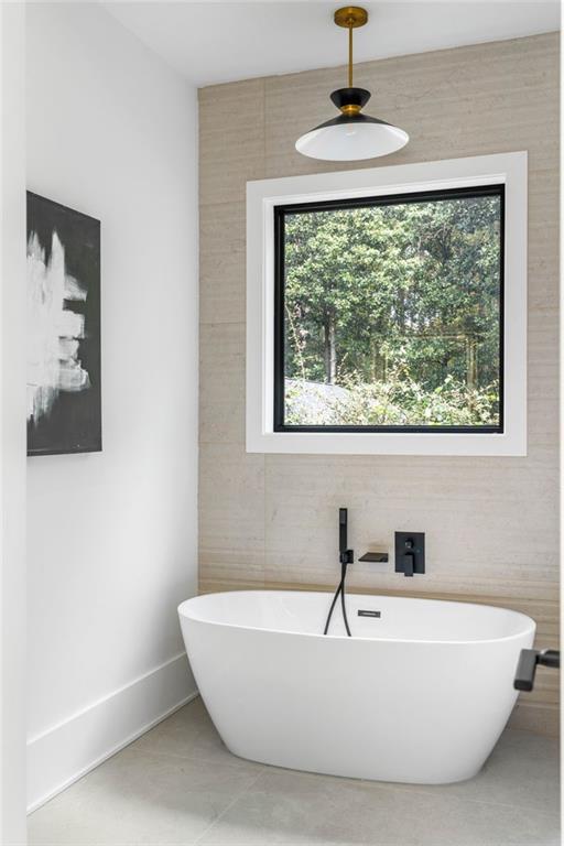 605 Hunnicutt Road Southeast Mableton, GA 30126 - Photo 27 of 35 a bathroom with a bathtub and a window