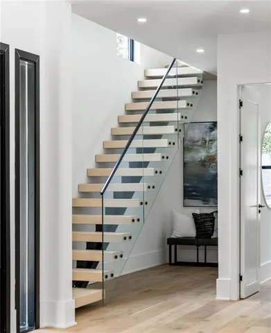 a view of entryway and hall with wooden floor