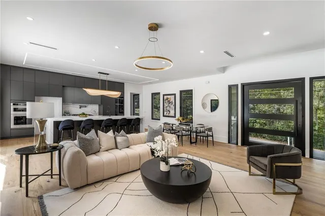 a living room with furniture a rug and a large window