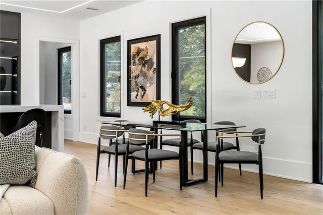 a dining room with furniture and a mirror