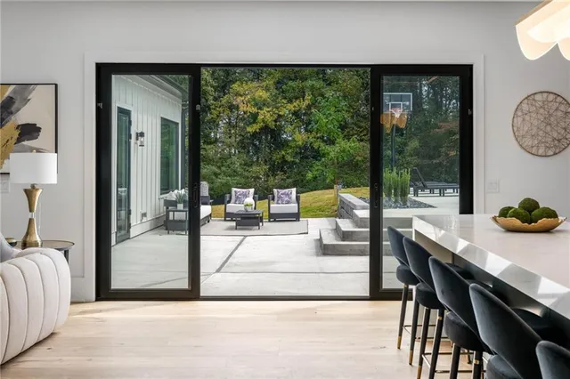 a living room with a large window and a table
