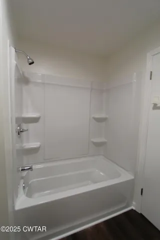 a bathroom with bathtub and shower