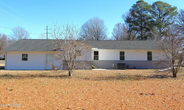 a house that has a tree in front of it